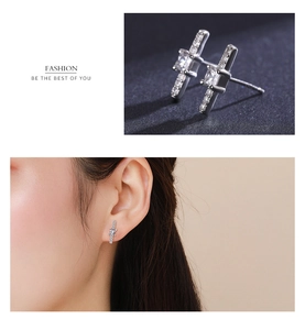 Detailed close-up and model view of S925 sterling silver cross stud earrings with zircon