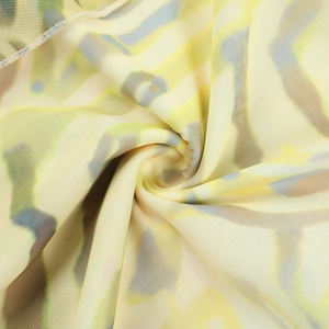 Detail of soft breathable mesh fabric featuring vibrant yellow and blue abstract prints