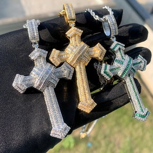Hip hop cross pendants with sparkling white and green zircons held in hand