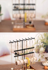 Detail of multi-tier black jewelry stand with earring slots and wood base stand