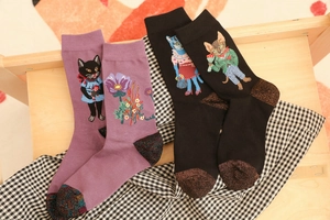 Close-up of cat and flower jacquard patterns on purple and black knit cotton socks