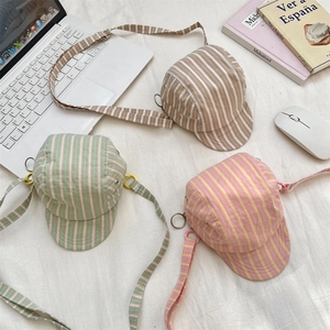 Flat lay of creative baseball cap shaped striped canvas crossbody bags in vibrant colors