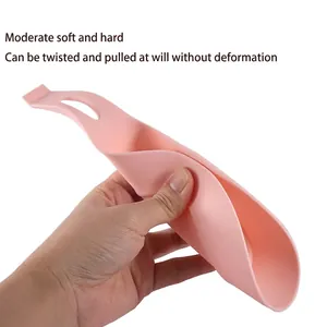 Pink flexible food-grade silicone spoon rest with hanging hole and durable material