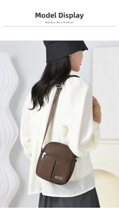 Deep brown nylon crossbody bag with multiple zipper pockets worn by a model