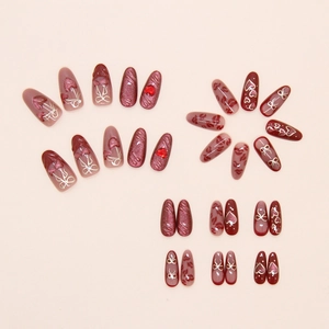Detail of cat-eye heart cherry press-on nails with 3D rhinestones and golden bow designs