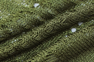 Macro shot of dark olive green mesh knit fabric with subtle sheen and hollow-out texture