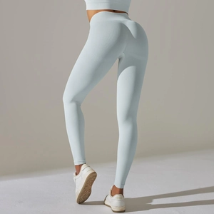 Detail of high-waisted seamless yoga leggings in light blue with rib-knit texture