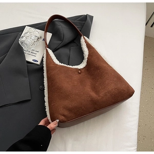 Detail of contrast stitch tote bag featuring brown suede and white fleece textures