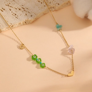 Gold chain necklace with colorful stones, heart pendant and green evil eye flower beads