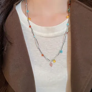 Colorful gemstone woven rope necklace featuring teardrop and irregular stone pendants