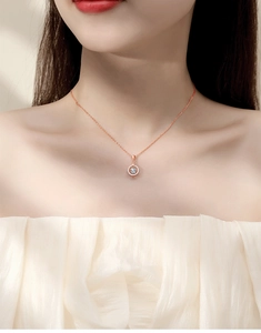 Close-up of rose gold Moissanite dancing heart pendant necklace on female model neck