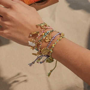 Handmade ocean woven bracelet set with gold pendants like shell, starfish and anchor