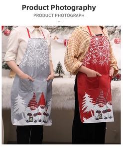 Detailed view of Christmas gnomes and snowflake prints on linen apron with front pocket