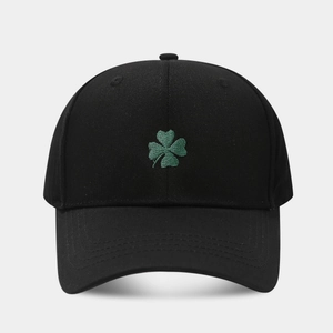 Classic black baseball cap featuring green four-leaf clover embroidery on front panel
