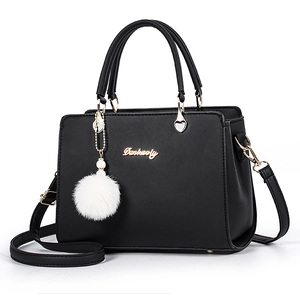 Classic black faux leather handbag for women with gold hardware and plush pompom charm