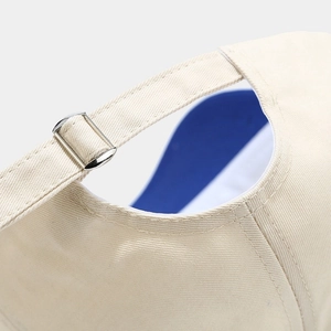 Adjustable beige cotton baseball cap back detail with metal buckle and blue lining