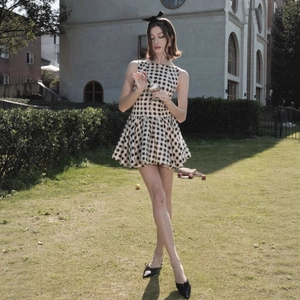 Classic black and white gingham sleeveless dress with high waist and button detail