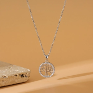 Macro detail of silver Tree of Life pendant featuring brilliant white zircon stones