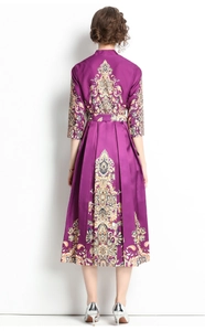Rear view of a purple midi dress with golden vintage patterns and elegant satin texture