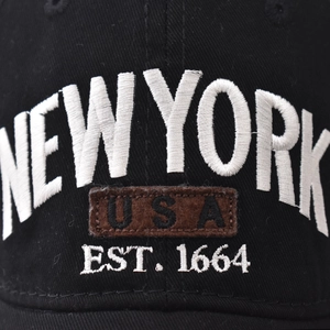Black cotton baseball cap featuring white NEW YORK embroidery and USA patch detail