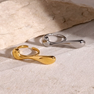 Minimalist 18k gold and silver stainless steel drip rings on natural stone