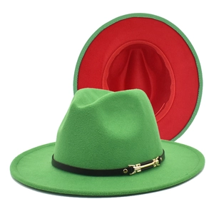 Close-up of green and red fedora hat featuring black leather band with golden buckle