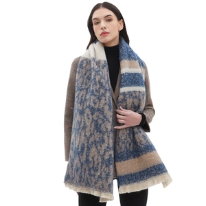 Winter leopard print scarf in blue and beige with thick fringe worn by a model