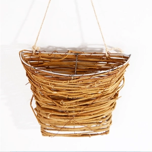 Detail of handmade woven wicker flower basket with rustic jute hanging rope and metal frame