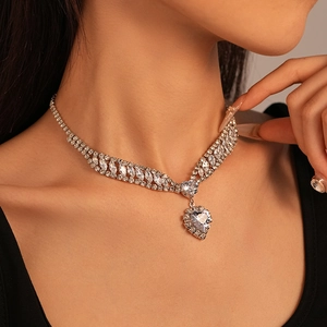 Close-up of luxury heart-shaped zircon necklace with V-shaped diamond cluster on a model