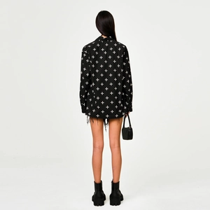 Back view of black cotton shirt with white cross patterns and oversized relaxed fit design