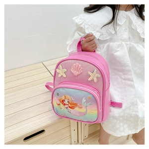 Detail of pink mermaid backpack featuring glitter fabric and cute shell accessories