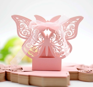 Detail of pink laser-cut butterfly candy box with silk ribbon and flat-packed card
