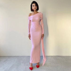 Detail of pink off-shoulder dress featuring elegant pleats and long decorative ribbons