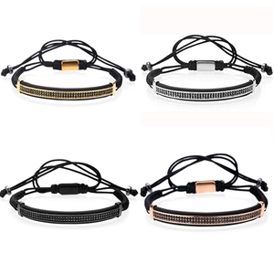 Detail of beaded rope bracelets with curved zircon bars in gold, silver, black and rose gold