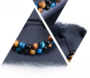 Macro detail of natural tiger eye and obsidian beads on adjustable braided rope bracelet