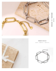 Detail of chunky gold and silver chain bracelets with logo tags on stone background