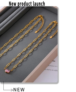 Close-up of 18k gold-plated paperclip chain necklace with a square pink zircon pendant