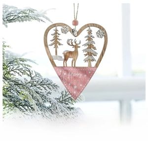 Detail of pink wooden heart ornament with reindeer carving and small bell for Christmas