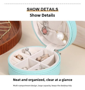 Detail of round PU leather jewelry box with compartments for rings and necklaces