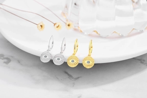 Detail of S925 sterling silver evil eye hoop earrings in gold and silver finishes
