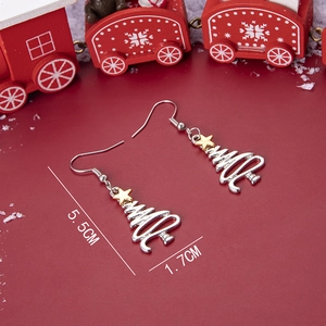 Silver Christmas tree earrings with gold stars on a red holiday background