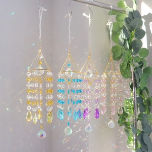 Detailed view of colorful K9 crystal suncatchers creating vibrant rainbow light reflections