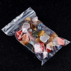 Mix of colorful natural crystal frog figurines in a transparent packaging bag
