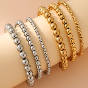 Close-up of gold and silver beaded bracelets in 4mm, 6mm, and 8mm sizes with mirror finish