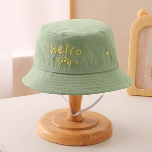 Detail of green cotton kids bucket hat with hello embroidery and white windproof strap