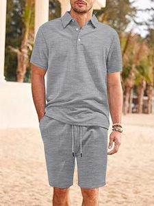 Detail of light gray waffle knit texture on men's polo shirt and beach shorts set