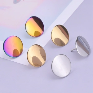 Macro detail of round geometric stud earrings in silver, gold, and rainbow finishes