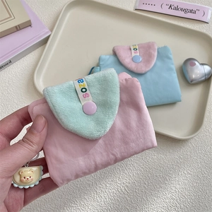 Close-up of cute nylon coin purse with plush flap and cartoon bear pendant detail