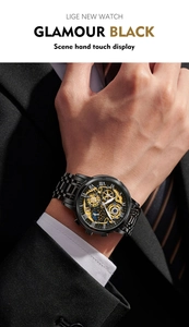 Close-up of black stainless steel quartz watch with gold hollow dial on business suit