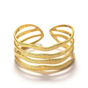 Macro shot of gold geometric bangle featuring a multi-layer open design and hammered texture